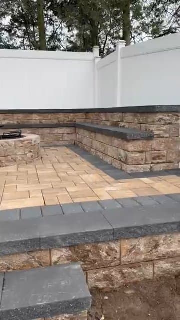 Backyard paver patio with stone retaining wall, steps, and a gazebo.